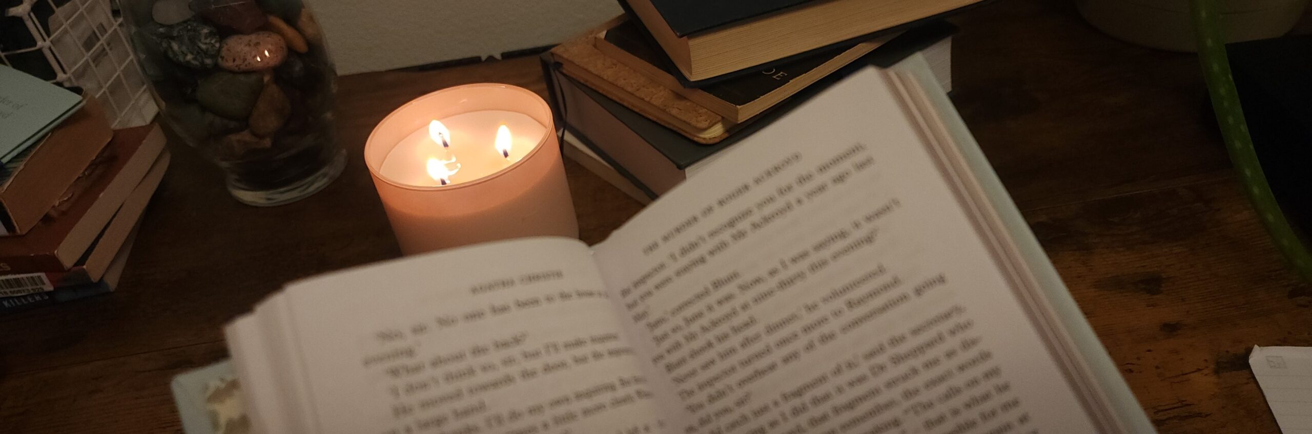 photo of books with a candle to showcase a writing forum to help me write